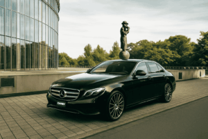 A black Mercedes-Benz sedan parked on a paved area