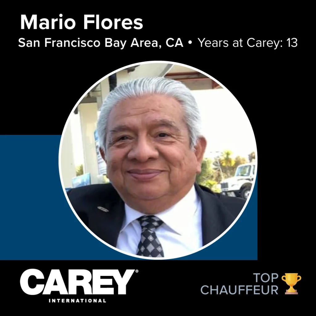 Portrait of a person with gray hair wearing a dark suit, white shirt, and patterned tie, face intentionally blurred for privacy; award recognition graphics and text are present