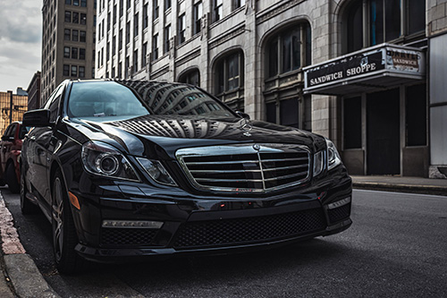 black mercedes benz luxury car parked on the street